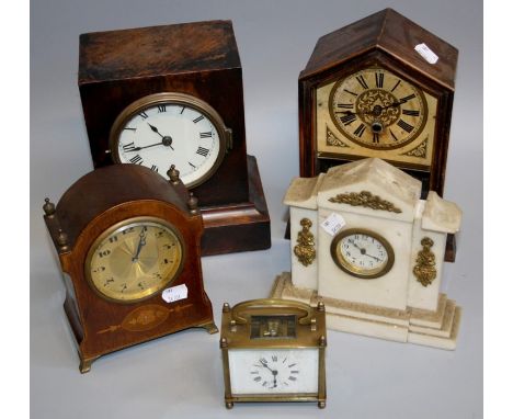 An Edwardian mahogany mantle clock, the dome case with brass urn finials enclosing an eight day movement faced by gilded Arab