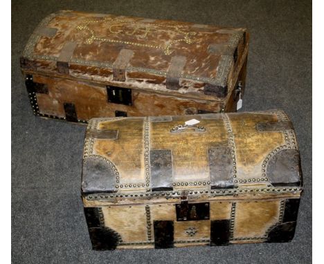 A 19th century pony skin, metal bound and close studded dome top trunk, initialled G J P, 84cm, together with a similar small