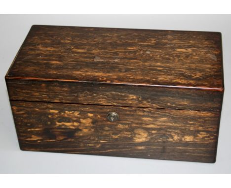 A 19th century coromandel tea caddy of rectangular form with bramah lock, twin lidded cannisters and provision for mixing bow