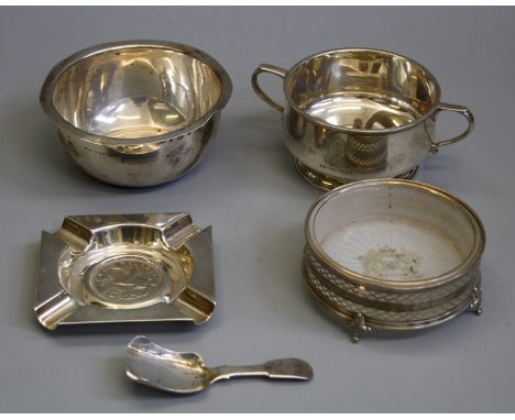 A silver shallow rim bowl, a silver twin handled sugar, a 1935 crown set silver ashtray, a silver caddy spoon and a silver bu