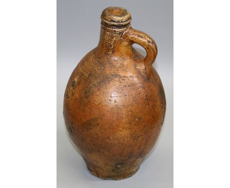 A possibly 18th century Bellarmine type salt glazed stoneware flask of baluster form with simple loop handle. 32cm