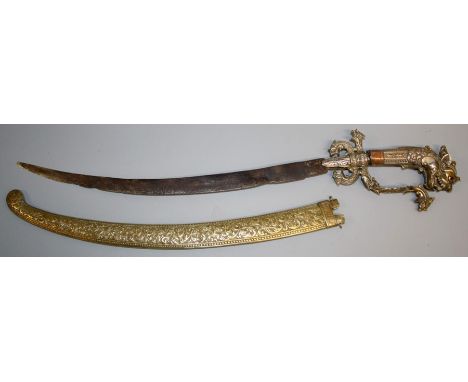 A late 19th century gilt metal Sinhalese dagger with curved single edge blade, typical form guard and Makara head pommel, in 