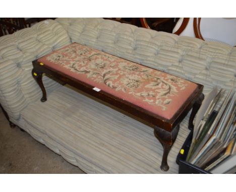 An oak oblong stool with needlework drop in seat