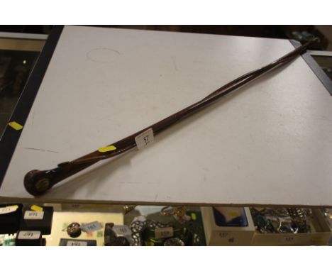 A wooden entwined swagger stick inlaid with The Royal Army Medical Corps button