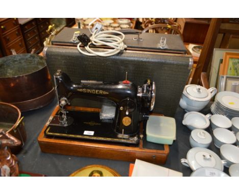 An electric Singer sewing machine with carrying case - sold as collector's item