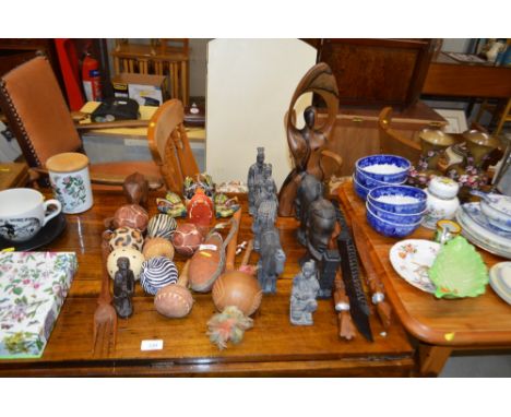 A collection of carved wooden ethnic ornaments; terracotta army figures etc