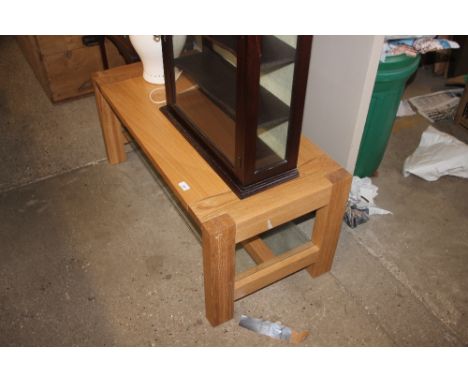 A light oak effect and glass coffee table 