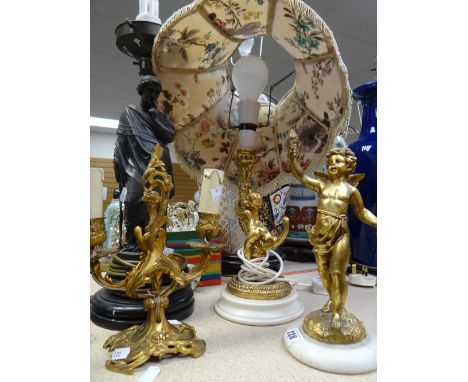 A gilded cherub mounted table lamp base &amp; shade, a cherub ornament on a marble base, a small gilt metal twin-branch cande