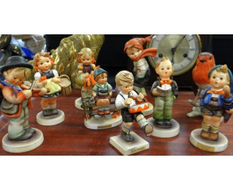 Eight Goebel infant figurines together with a Goebel robin red-breast on a bough Condition reports provided on request by ema