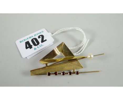 A 9ct yellow gold contemporary abstract brooch set with single pearl and row of red stones / rubies, 4.8grams Condition repor