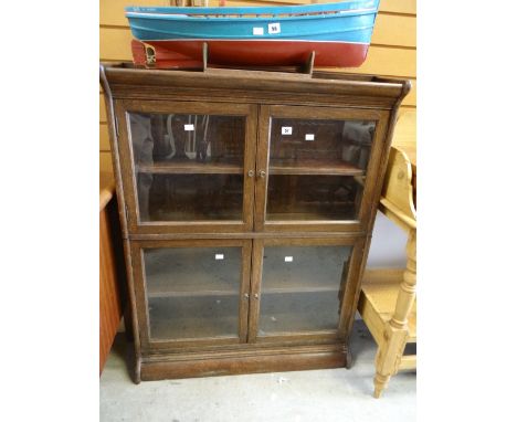 A vintage two-section glazed and oak library bookcase Condition reports provided on request by email for this auction otherwi