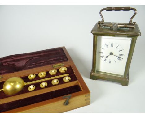 A brass and glass carriage clock together with a vintage cased liquid measure set Condition reports provided on request by em