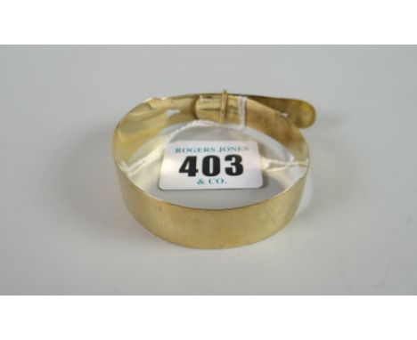 A 9ct yellow gold bangle in the form of a belt with buckle, 10 grams Condition reports provided on request by email for this 