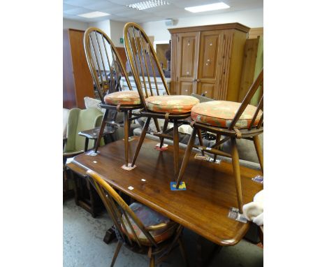 A mid-century Ercol dark wood refectory-type dining table and four matching hoop back chairs Condition reports provided on re