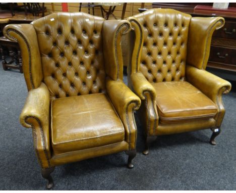 A pair of good studded and button back tan leather wingback armchairs Condition reports provided on request by email for this