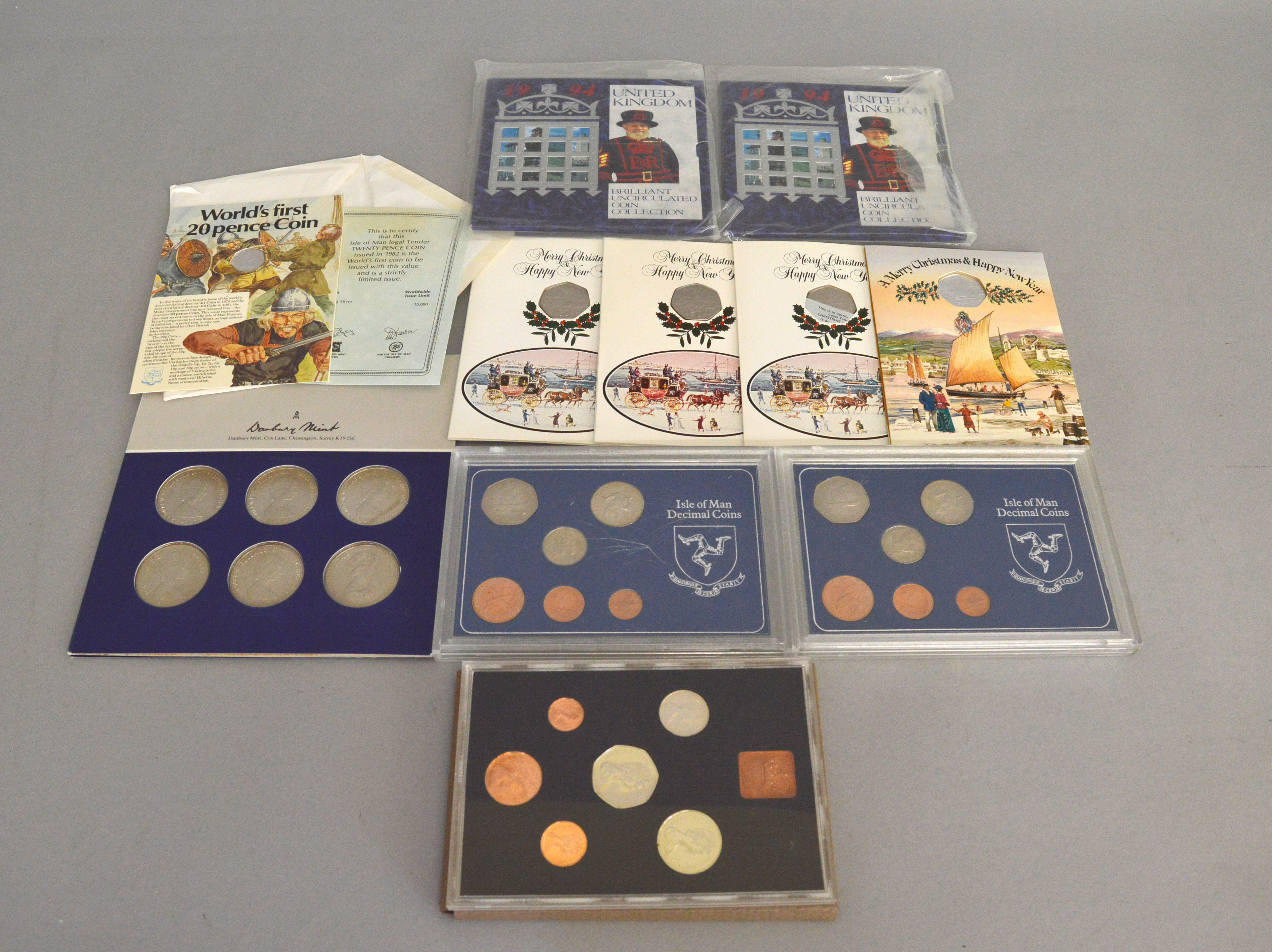 A quantity of coin covers to include two 1994 uncirculated coin