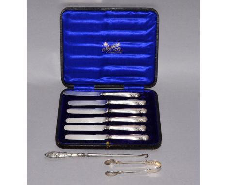 A cased set of six silver handled dessert knives, together with a pair of silver sugar tongs & a silver handled button hook 