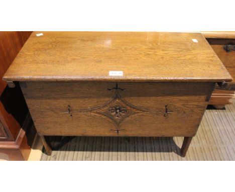 A small oak trunk with carved front and lift up lid