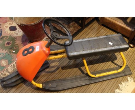 A child's steerable sledge/skidoo