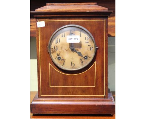 An early 20th century chiming mantel clock, the mahogany case with circular dial having Arabic numerals, with pendulum and ke