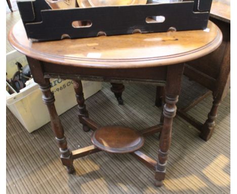 An oak side table with turned legs and under tier shelf