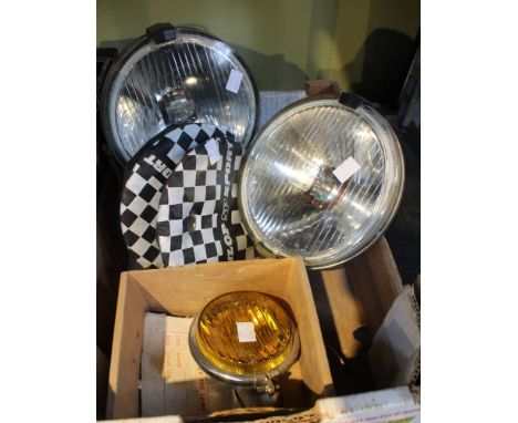 A box containing a pair of vintage car spot lights etc