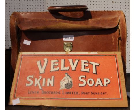 A vintage leather briefcase once owned by Norman Painting together with a Levers Brother wooden advertising board
