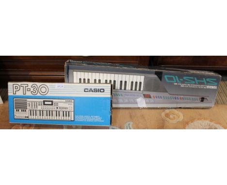 A Yamaha digital key board in original box with a Casio PT-30 key board in original box