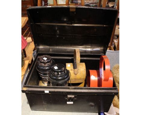 A black metal trunk containing two tilley lamps & two old fashioned roadside lamps