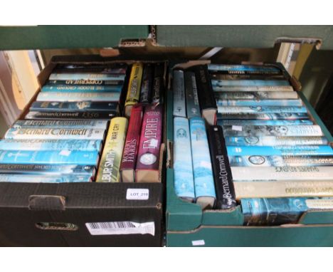 Two boxes containing a selection of Bernard Cornwell novels including first editions