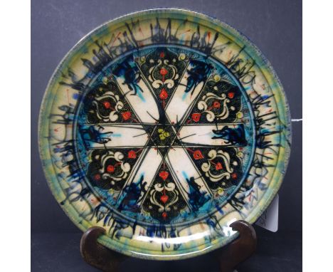 A Persian glazed ceramic dish, decorated with stylised floral motifs, marked and dated to base, H.4.5cm Diameter 26.5cm 