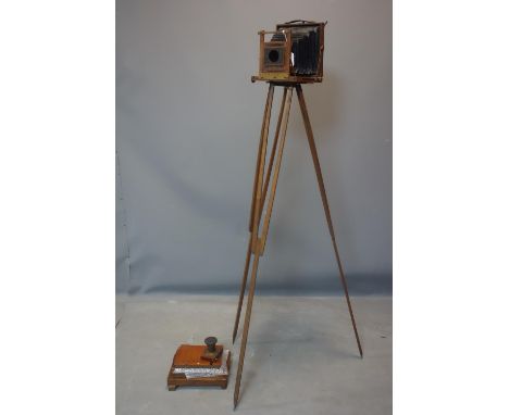 A Victorian field camera with tripod, negative holders and printing device, lens loose from camera 