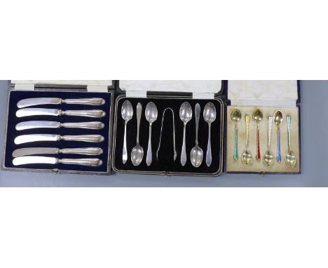 A cased set of six Danish gilt sterling and polychrome enamel coffee spoons, a cased set of six silver teaspoons with tongs a