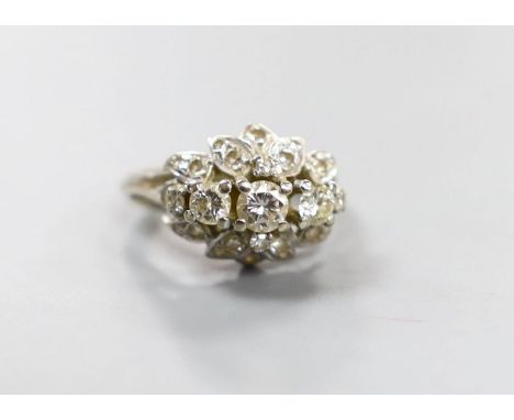 A white metal and three stone diamond ring with diamond cluster setting, size M, gross weight 4.4 grams.