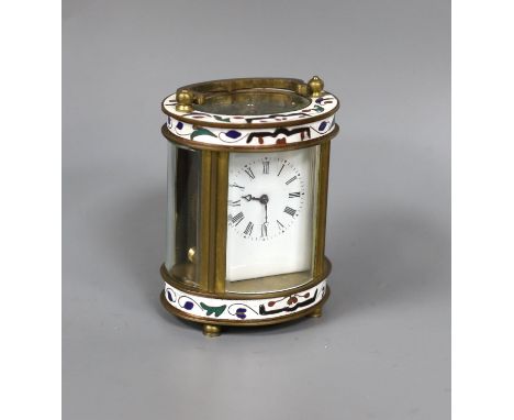 An oval brass and champleve enamel carriage timepiece, 9cm