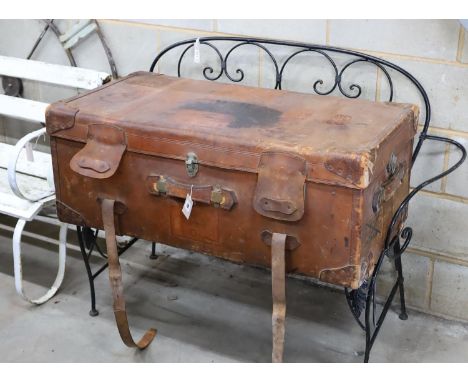 An early 20th century large tan leather trunk with labels, length 100cm, depth 53cm, height 39cm