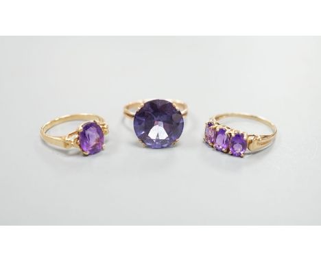 Two modern 14k yellow metal and gem set rings, including amethyst, size N, gross weight 7.4 grams and a similar 10k and three