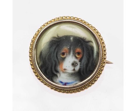 A VICTORIAN ENAMEL NOVELTY BROOCH a circular plaque enamelled with a portrait of a King Charles Spaniel, in a rope frame, 2.2