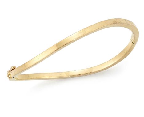AN 18 CARAT GOLD BANGLE of hinged twisted form. Hallmarked Birmingham 2002, 5.5cm by 6cm inner diameter, 7.7 gramsLight surfa