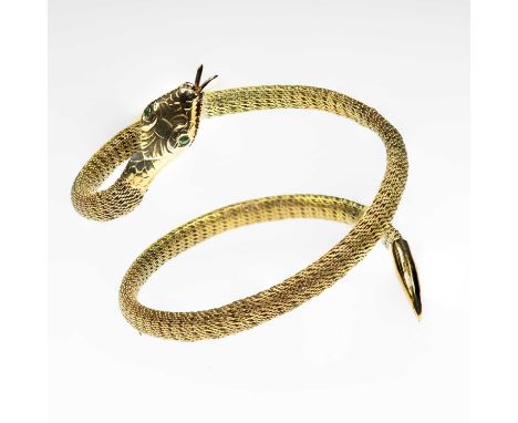 A SNAKE BANGLE a coiled woven body with an open mouth and emerald inset eyes. Marked '9CT', 4.8cm inner diameter, 7cm wide, 1