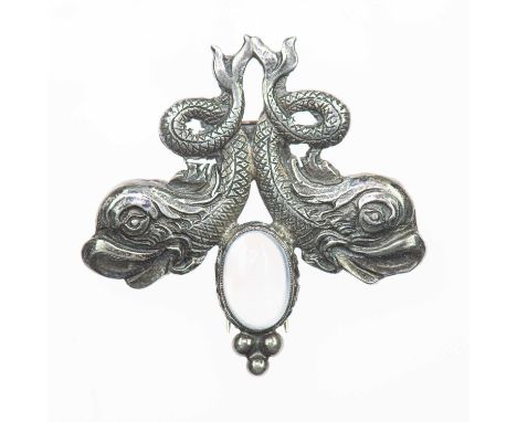 GUGLIELMO CINI FOR BLACK, STARR &amp; GORHAM - A SILVER AND MOONSTONE CLIP BROOCH an oval moonstone flanked by stylised dolph