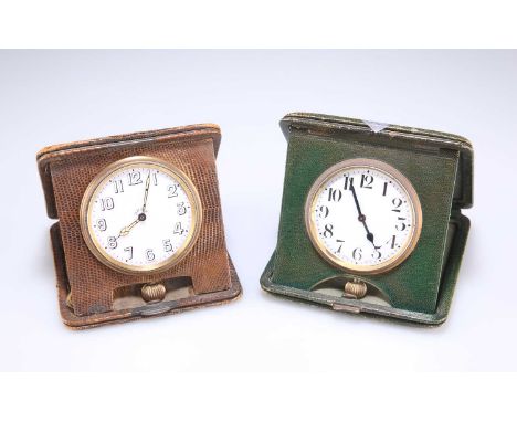 TWO GILT METAL TRAVEL CLOCKS the first with a circular white enamel dial signed 8 Days, with black Arabic index and outer min