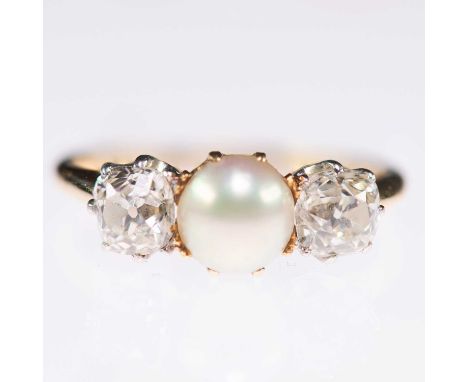 A SPLIT PEARL AND OLD MINE-CUT DIAMOND THREE STONE RING a split pearl between old mine-cut diamonds. Estimated total diamond 