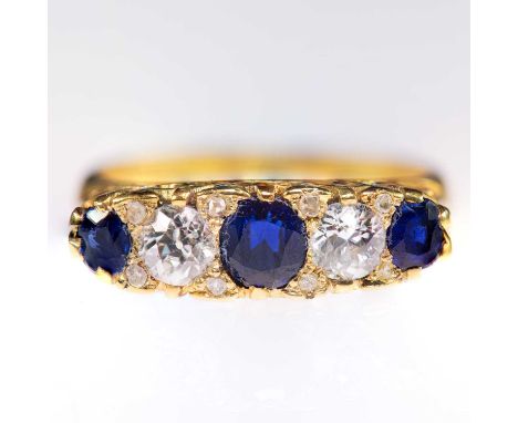 AN 18 CARAT GOLD SAPPHIRE AND DIAMOND RING three graduated cushion-cut sapphires spaced by old-cut diamonds, with diamond acc