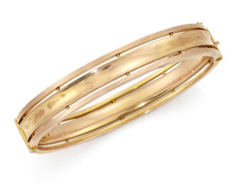 A LATE VICTORIAN HINGE OPENING BANGLE for rose and yellow concave bands. Indistinctly marked, 6cm by 5cm inner diameter, 1.1c