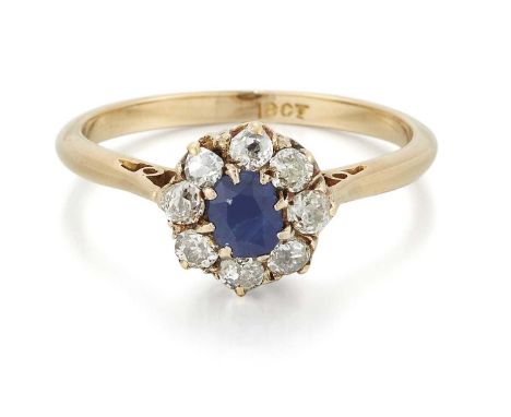 A SAPPHIRE AND DIAMOND CLUSTER RING a cushion-cut sapphire within a border of old-cut diamonds. Estimated total diamond weigh