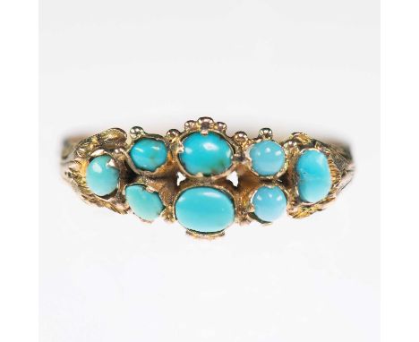 A MID-19TH CENTURY 9 CARAT GOLD TURQUOISE RING oval turquoise in beaded settings to fancy foliate cast shoulders and an engra