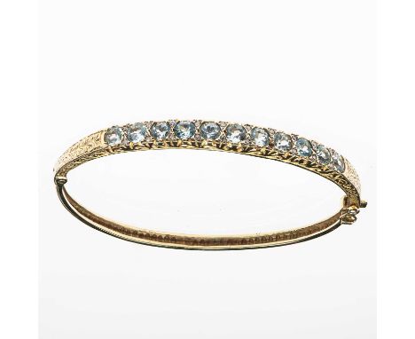 AN ANTIQUE STYLE AQUAMARINE AND DIAMOND HINGE OPENING BANGLE round-cut aquamarines spaced by diamond accents in carved settin