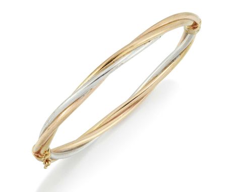 A 9 CARAT TRI-COLOUR GOLD BANGLE of hinged twisted yellow, white and rose gold bands. Hallmarked Sheffield, 5.5cm by 6.5cm in
