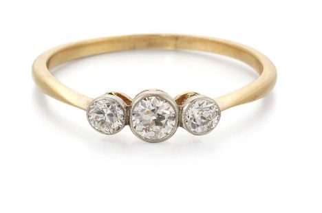 AN EARLY 20TH CENTURY DIAMOND THREE STONE RING graduated old-cut diamonds in milgrain settings. Estimated total diamond weigh